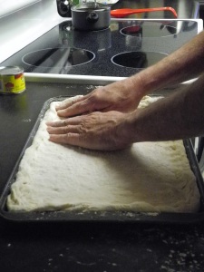 molding pizza dough in pan